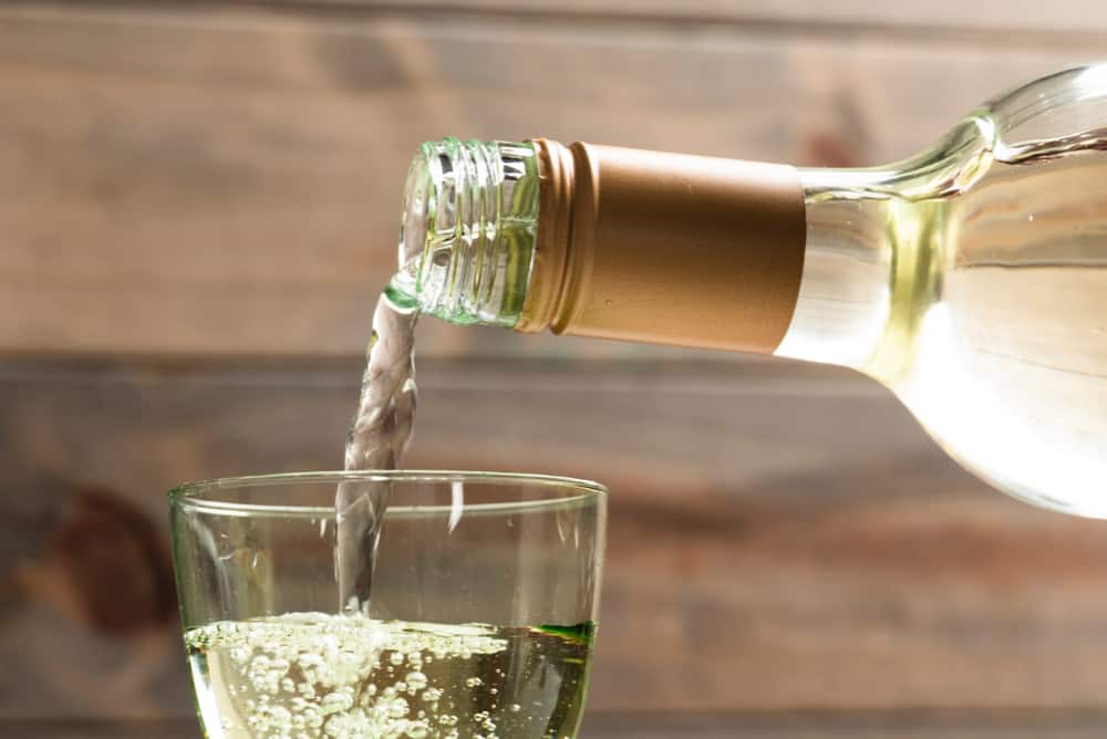 close-up-white-wine-poured-in-a-glass